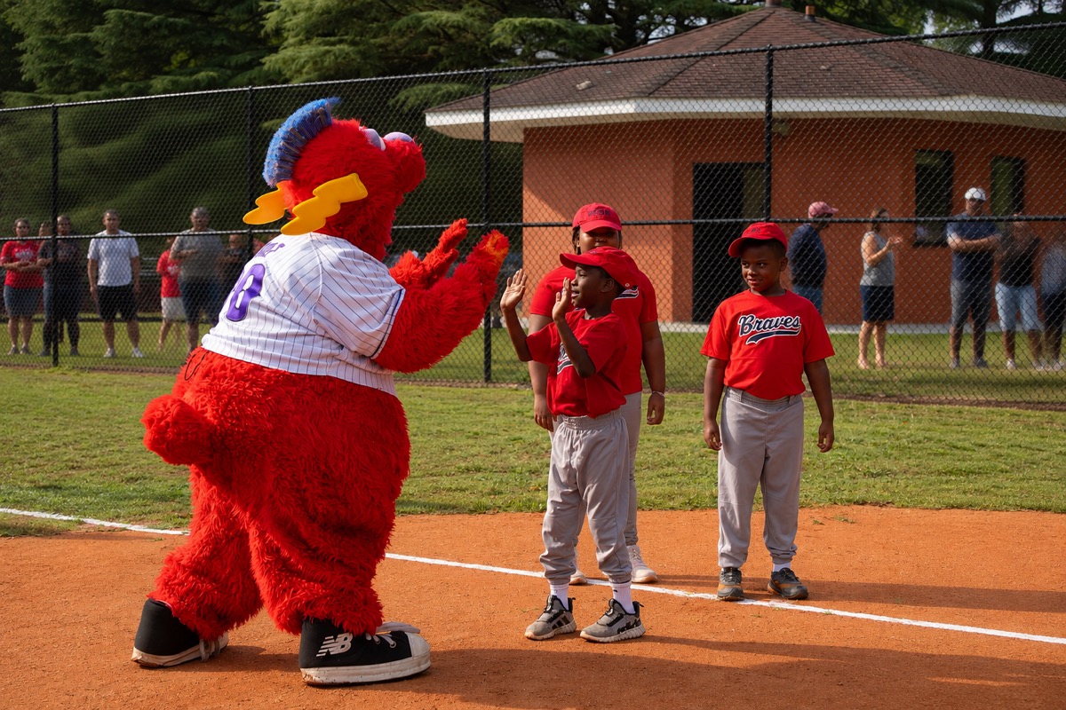 Team mascot with youth baseball players